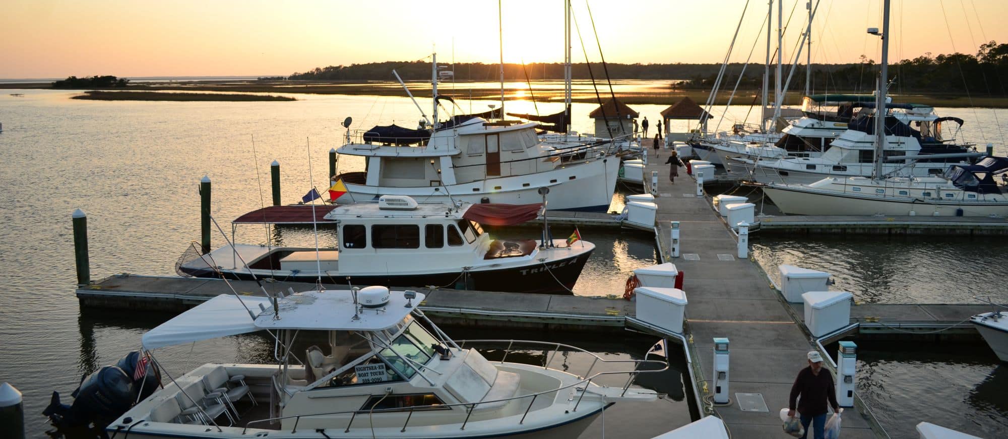 Boats docked at The Landings marina at sunrise.