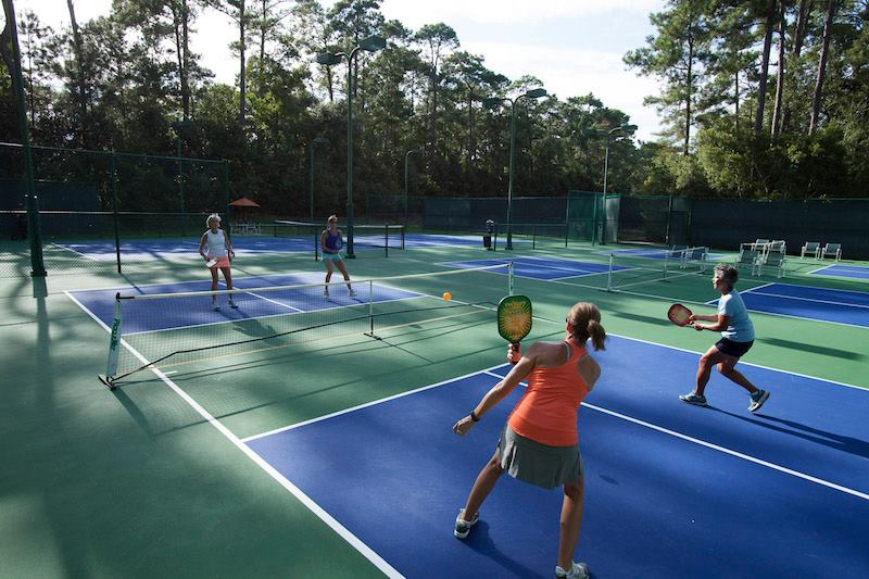 Pickleball players enjoy an evening of tournament play on several of the pickleball courts at The Landings.