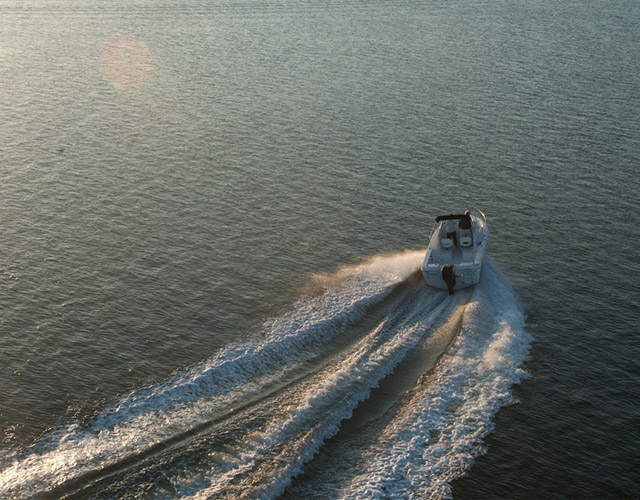A cabin-cruiser boat leaving one of the two deep-water marinas headed along the Georgia coastline.