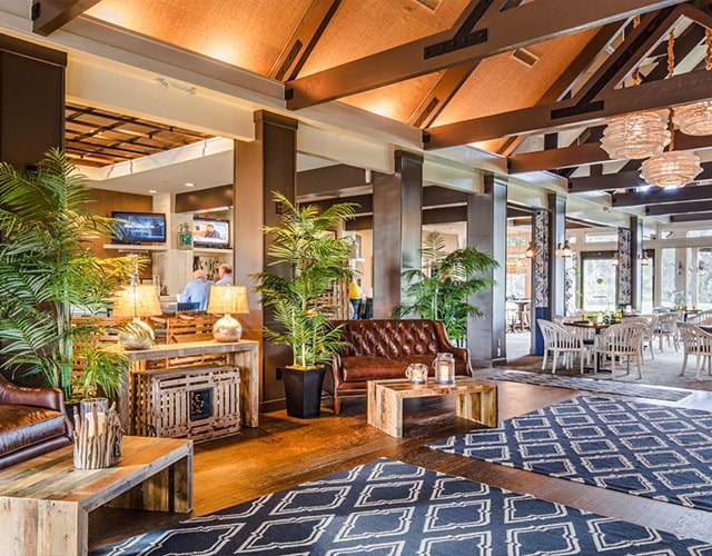 Well-appointed clubhouse lobby with wooden ceiling beams boasting a relaxed Southern living charm.