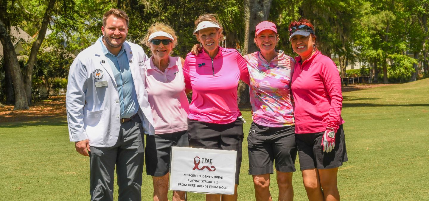 A group of women golfers in the LWGA are dressed in pink and gather together for a cure.