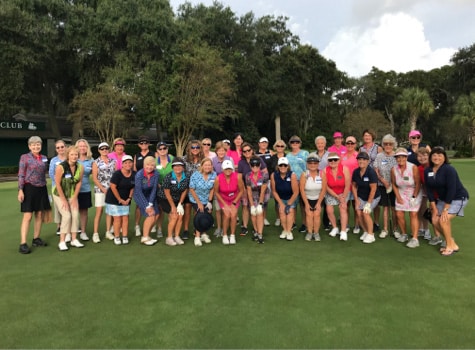 A large group of volunteers from the Landlovers philanthropic group gather on one of the six championship golf courses.