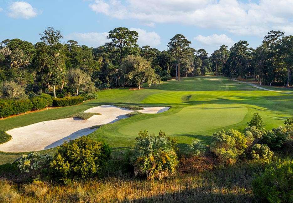 Rolling sand traps and greens surrounded by lush trees are the highlight of this Deer Creek golf course designed by Tom Fazio.