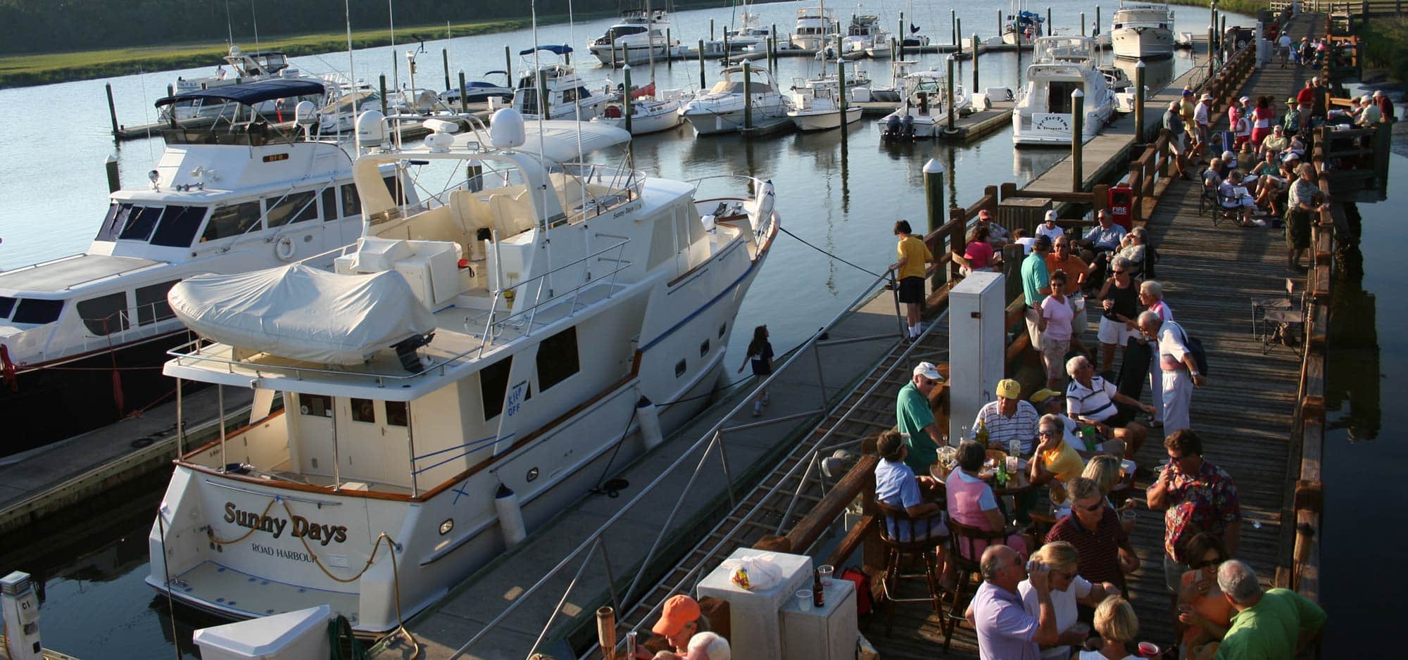 The Landings Association supports an evening dockside gathering at one of its marinas.