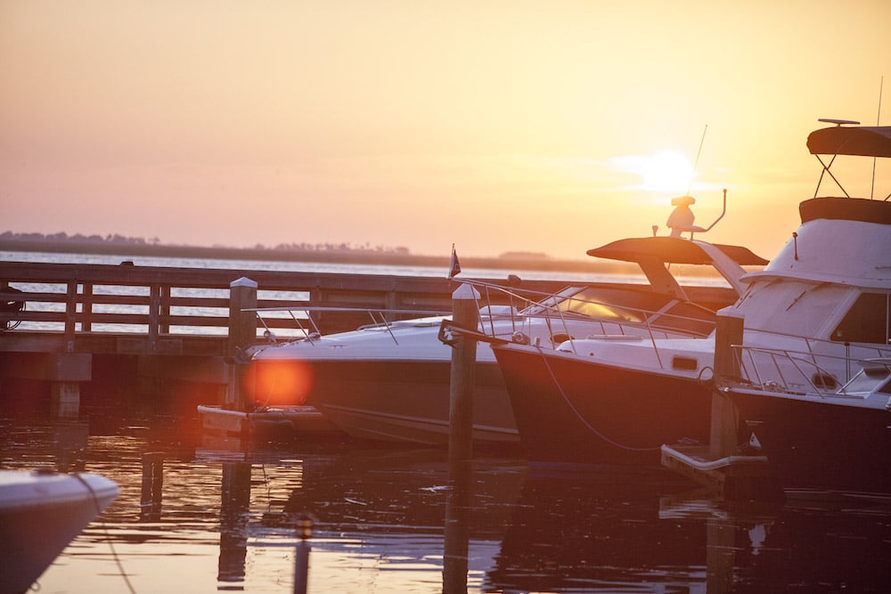 The bows of two boats docked at sunset at one of The Landings' marinas.