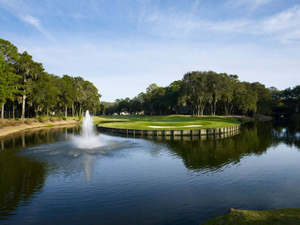 A fountain sprays water in a calm lagoon on one of The Landings' golf courses, named in the top 20 in the country.