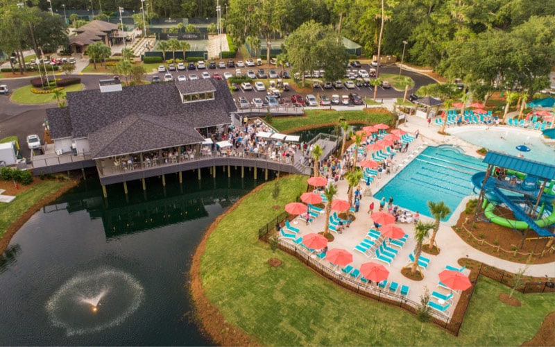 Aerial view of the Franklin Creek Activity Center featuring a resort-style pool and lagoon views.