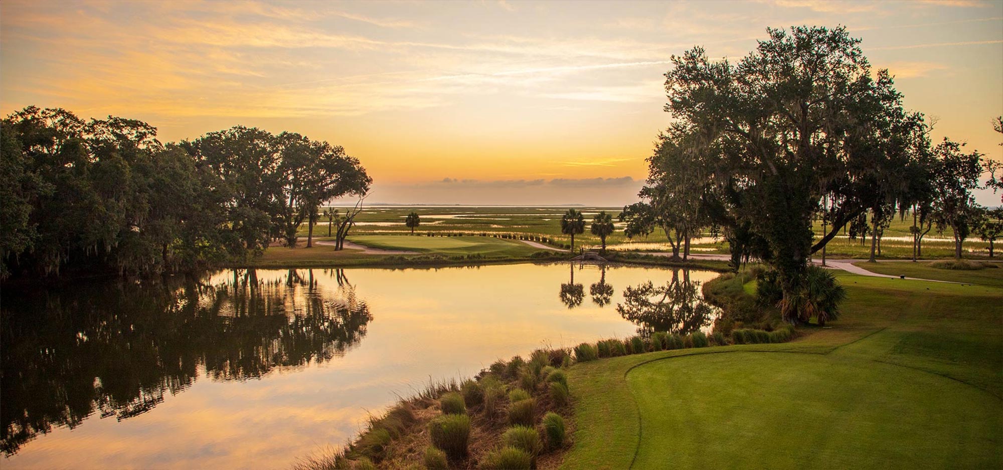 Sunset view of Romerly Marsh, the Marshwood golf course's 12th hole, lined with oak and pine trees, is considered the most scenic at The Landings.