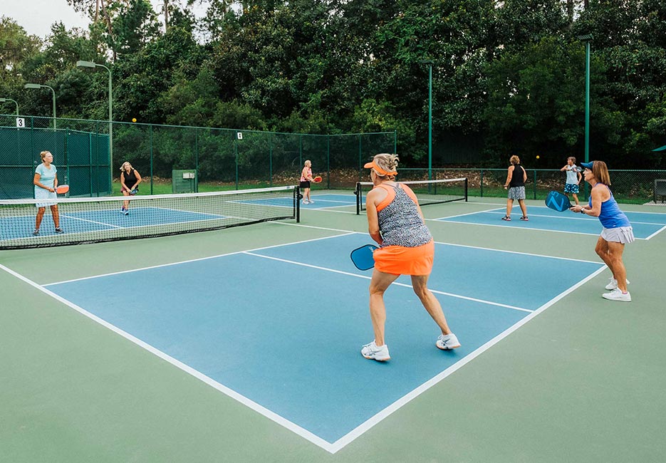 A group of women play on two of the 14 pickleball courts available as part of the Court Sports in the Athletic Club at The Landings.