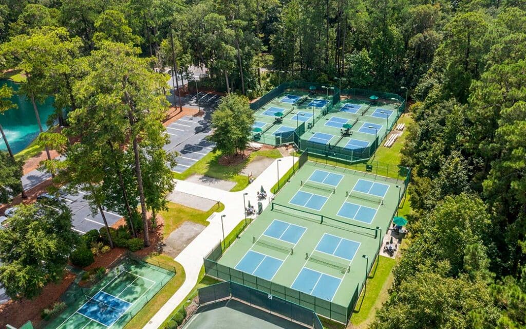 Birdseye view of the 14 pickleball courts nestled among large oak trees.