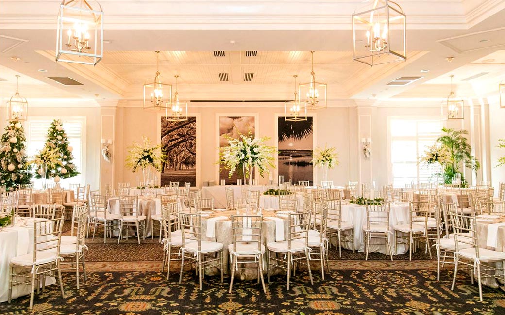 White linen tablecloths and silver chairs make this reception hall party ready.