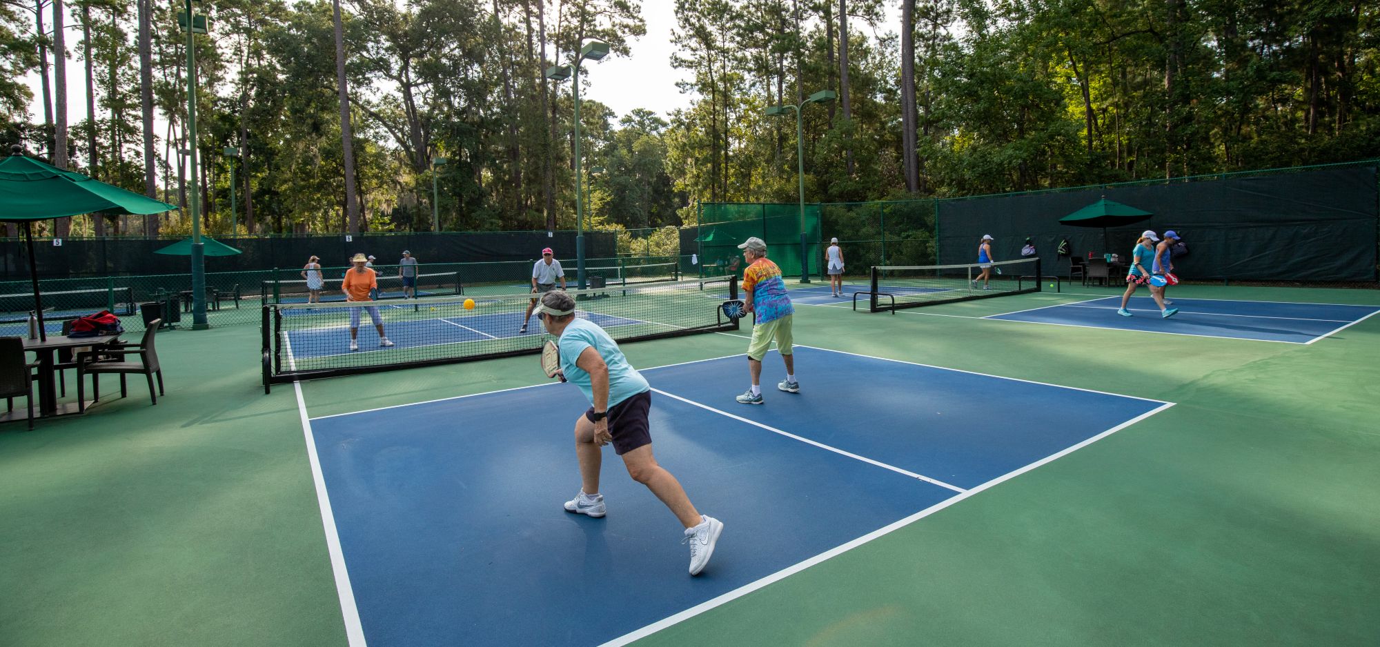 A couple plays another couple on one of the 14 pickleball courts.